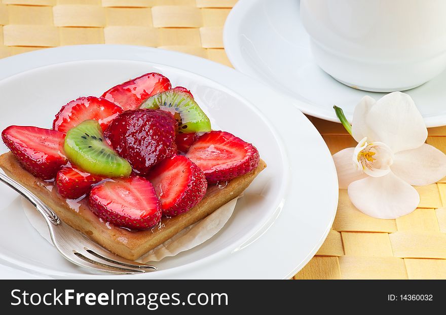 Strawberry cake with kiwi on white plate