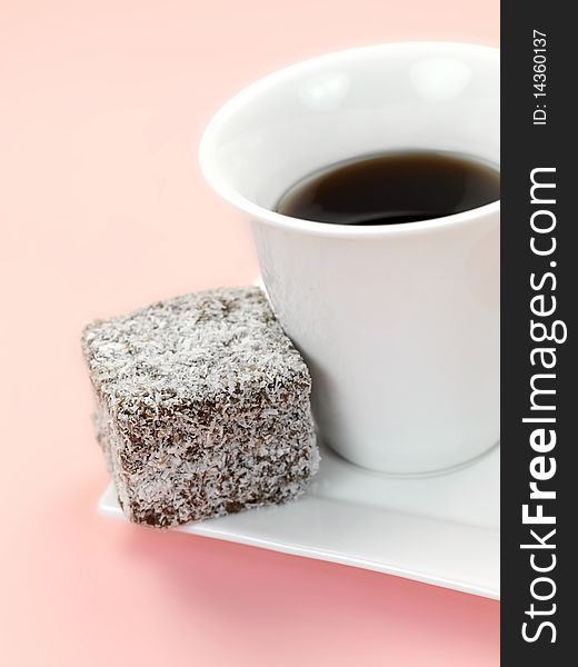 Small lamington cakes isolated against a pink background