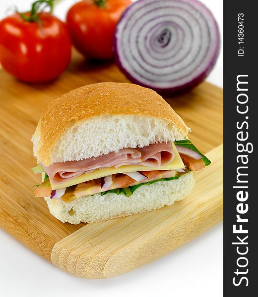 A ham and salad roll on a kitchen bench