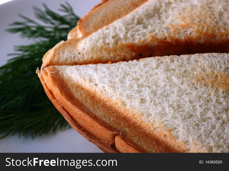 The close up of bread of which is made a sandwich in a roaster.