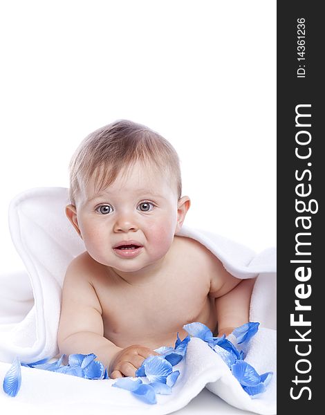 Beautiful baby under a white towel on white background