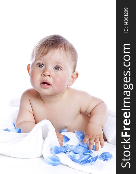 Beautiful baby under a white towel on white background