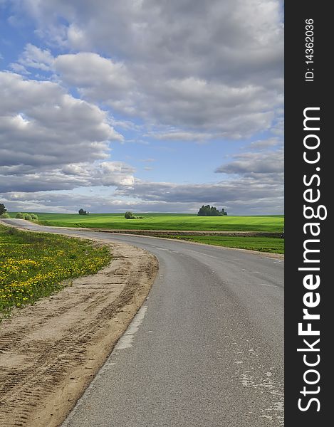 An empty rural road under a beautiful blue sky