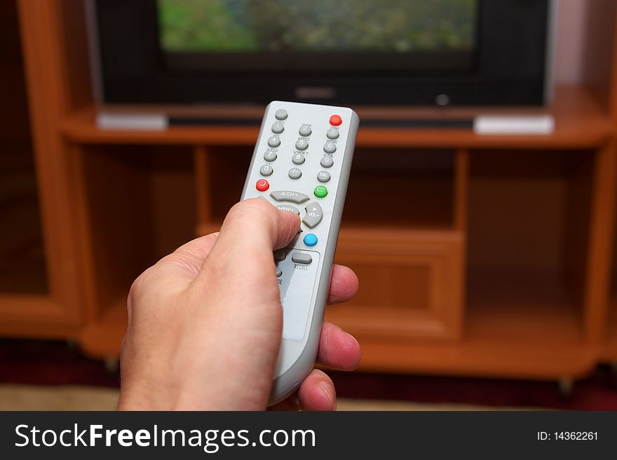 Photo of the hand with remote control