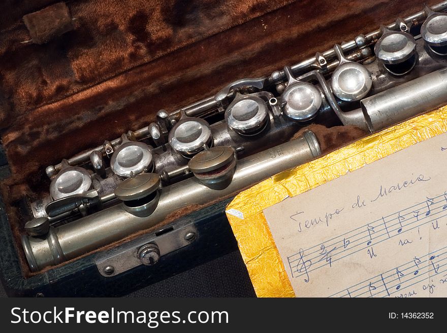 Silver like flute in his box near hand writen score