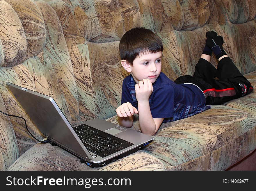 Small boy with notebook at home