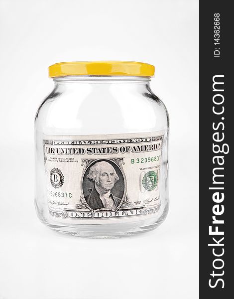 Dollar in a glass jar on a white background