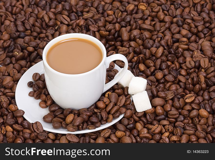 Cup of coffee at beans closeup