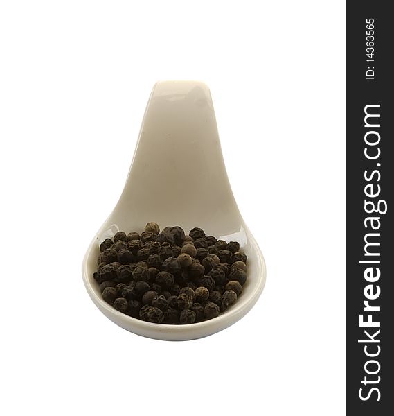Spoon whit black pepper, isolated in the white background