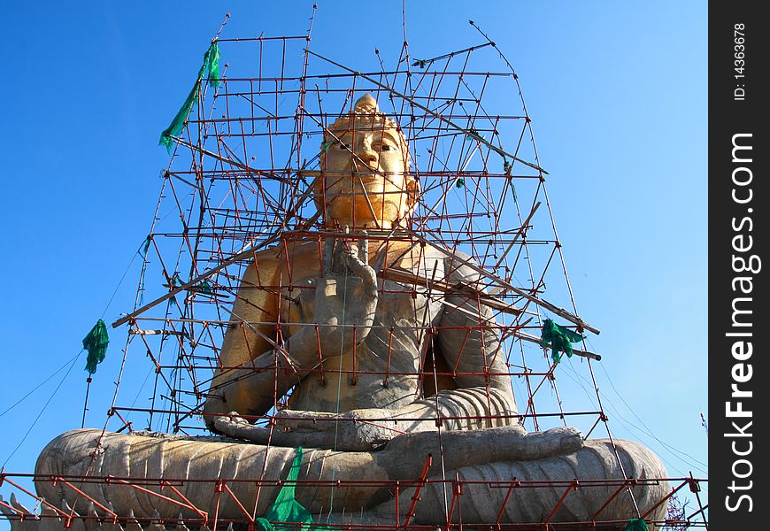 Golden Buddha under construction at top of the mountain, Phetchaburi Thailand