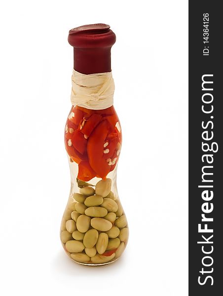 Decorative glass bottle with some red peppers and green beans
