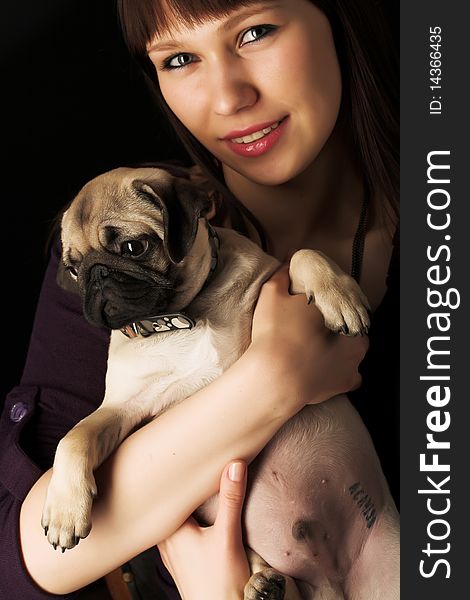 Girl and pug, studio shot