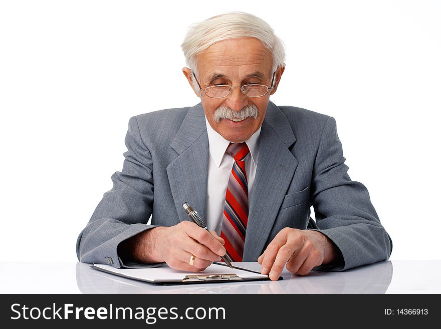 Portrait of an elder businessman writing something in the document over white. Portrait of an elder businessman writing something in the document over white.