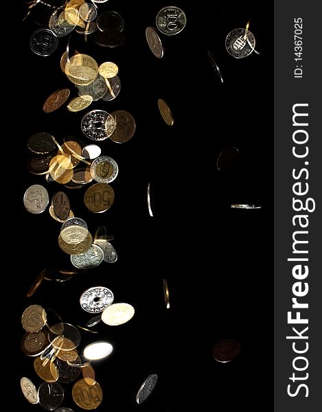Coins from different countries falling down on black background. Coins from different countries falling down on black background