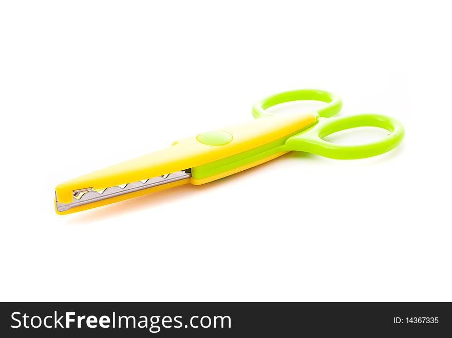 Green and yellow scissors isolated on white
