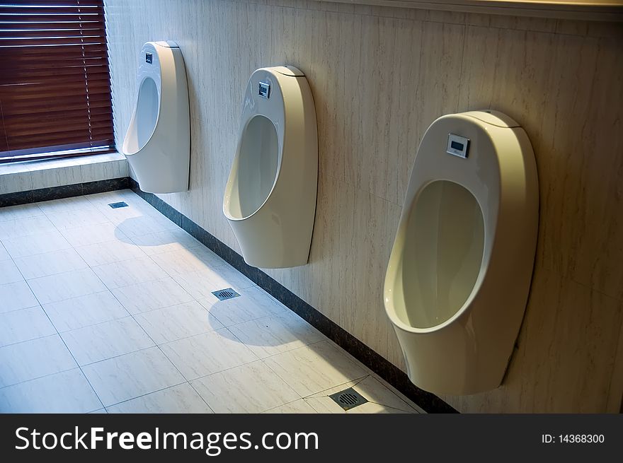 Row of  toilets in a man restroom