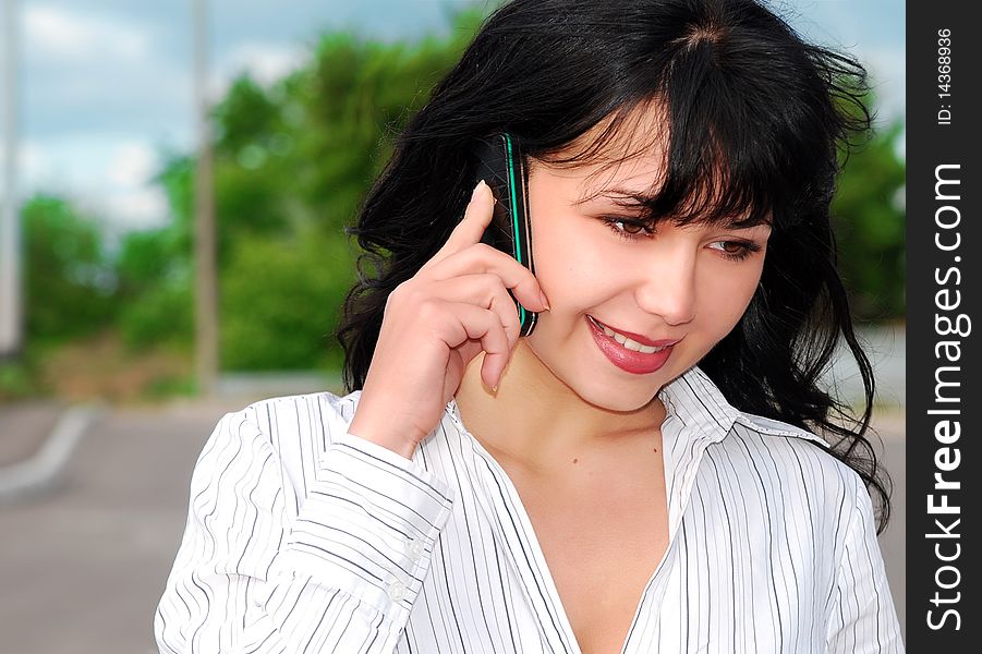 Young business woman talking on mobile phone