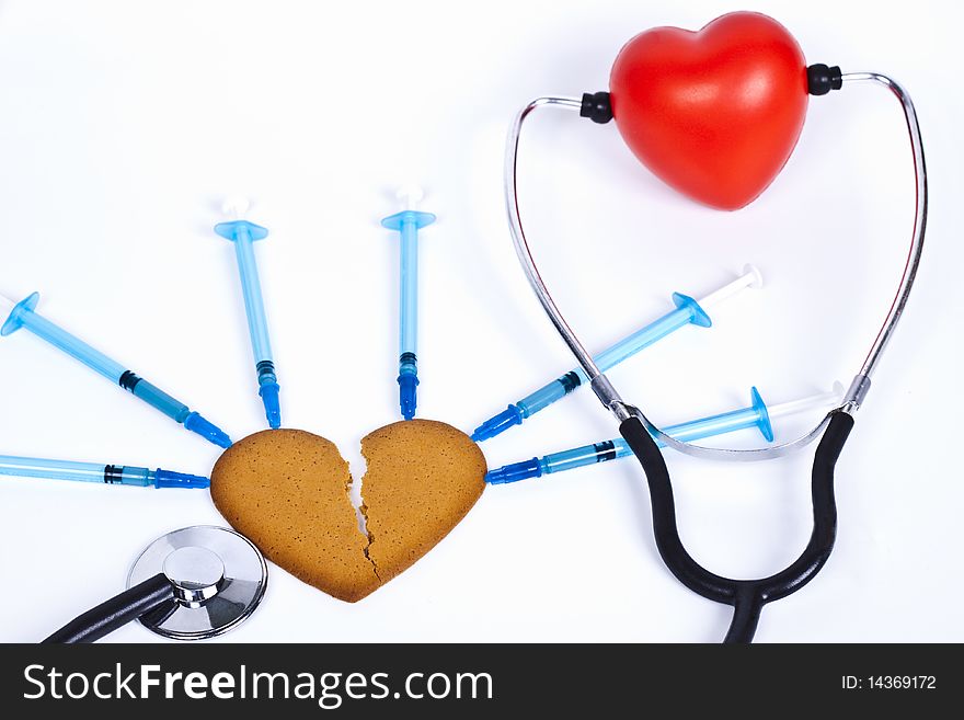 Healing a broken heart with blue syringe and a stethoscope