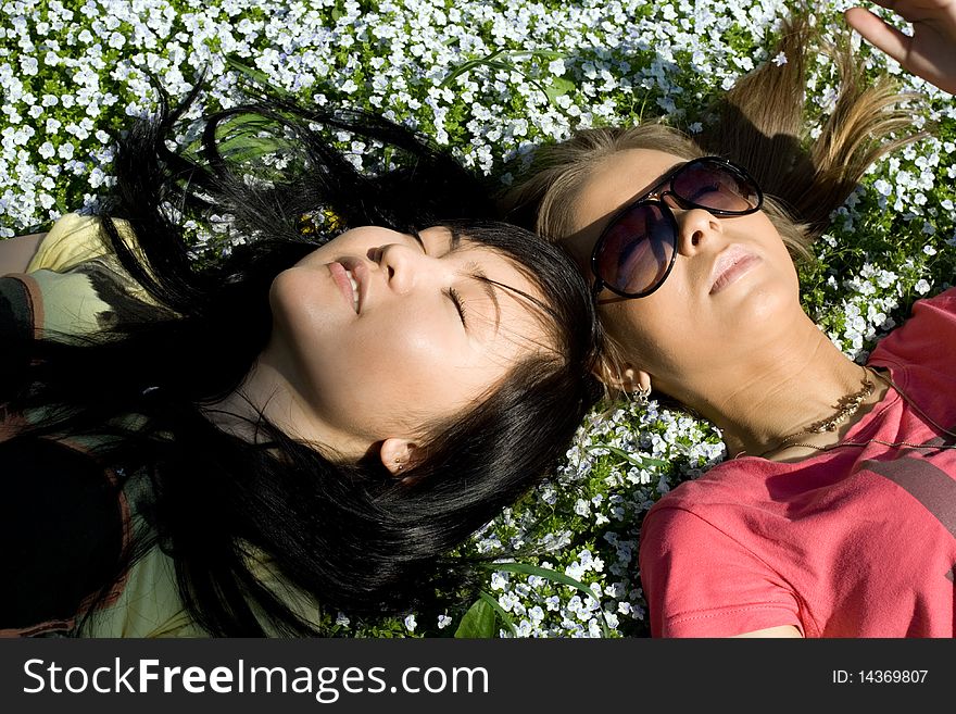 Two girsl lying on grass. Two girsl lying on grass