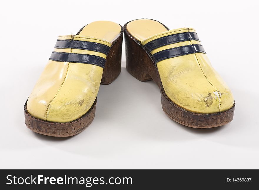 Old, worn vintage clogs. On white background. Old, worn vintage clogs. On white background.