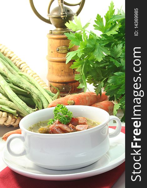 Green bean stew in a white soup cup