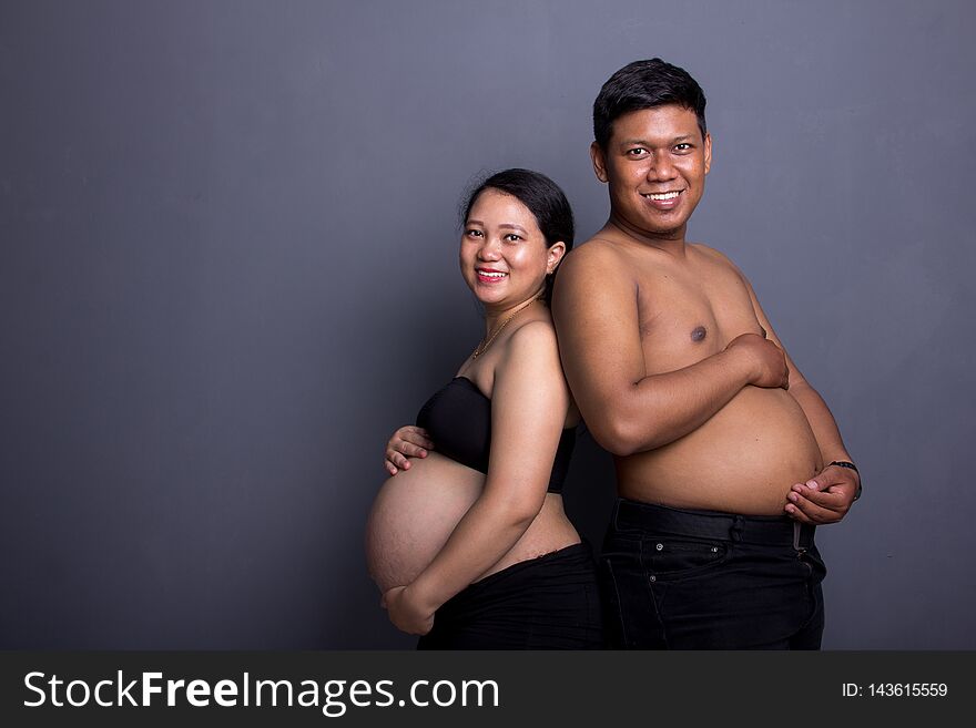 Pregnant couple and their big tummy
