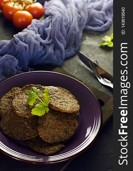 Spiced chicken liver pancakes with vegetables. Home fried chicken liver pancakes on dark board. Chicken liver side dish recipe. Rustic style. Selective focus