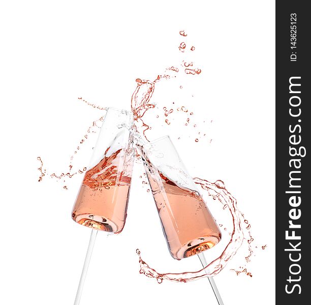 Glasses of champagne clinking together and splashing on white background