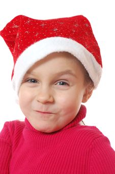 Funny Face Of Child Wearing Red Santa�s Hubcap. Royalty Free Stock Image Funny Face Of Child Wearing Red Santa�s Hubcap. Royalty Free Stock Image