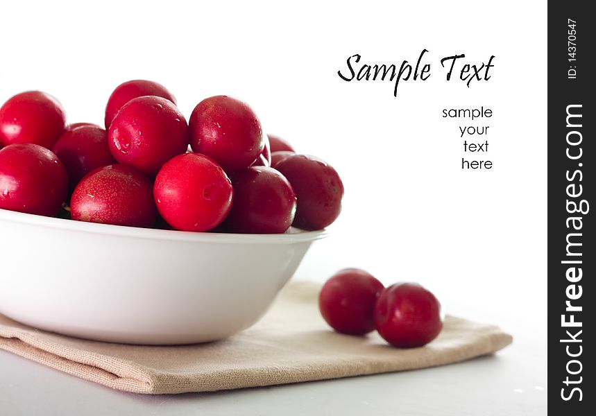 Red Plums on white background