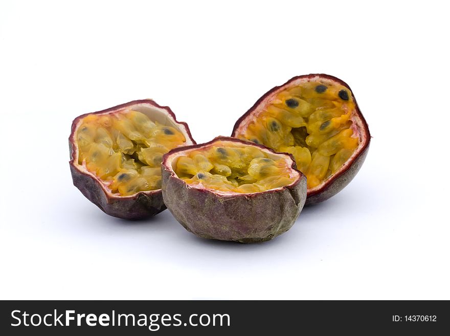 Three halves of passionfruits isolated on white. Three halves of passionfruits isolated on white