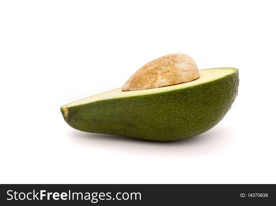 Half an avocado with stone isolated on a white background. Half an avocado with stone isolated on a white background