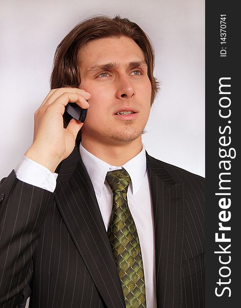 Young businessman with mobile phone in hand. Young businessman with mobile phone in hand