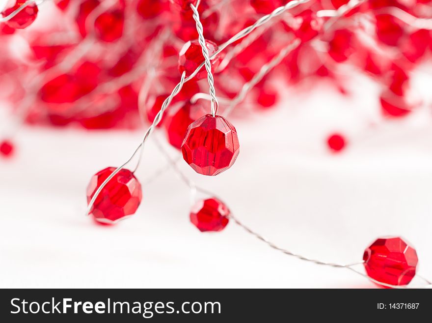 A chain  with red jewels isolated on white. A chain  with red jewels isolated on white