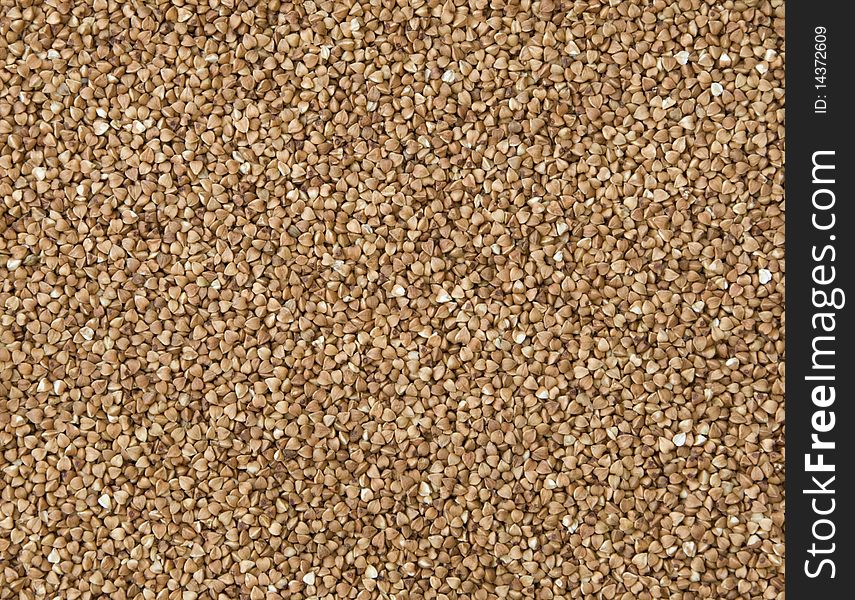 Buckwheat grains completely fill a background. Buckwheat grains completely fill a background