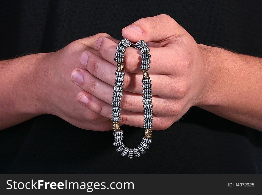 The religion theme, the man has control over rosary from metal.