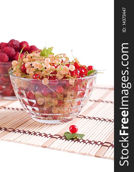 Fresh Raspberry and currant in a crystal bowl isolated