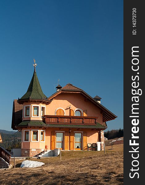 Big house on blue sky background