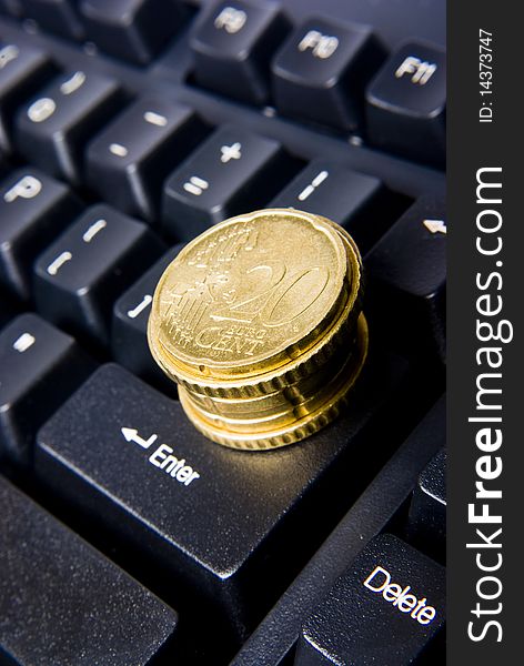 Keyboard with pile of coins. Keyboard with pile of coins