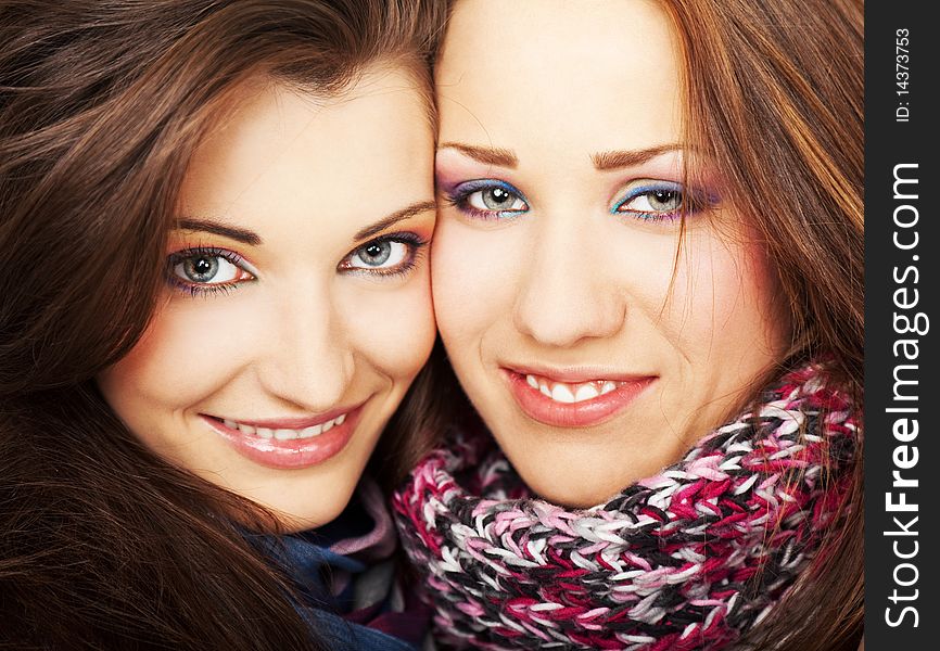 Close-up of two young beautiful girlfriends smiling. Close-up of two young beautiful girlfriends smiling