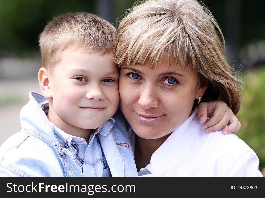 Happy mother and her little son outdoors session