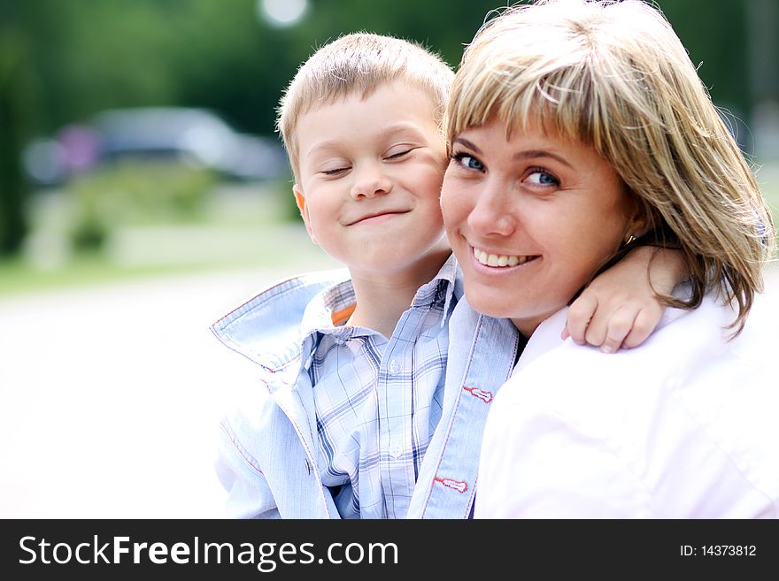 Happy mother and her little son outdoors session