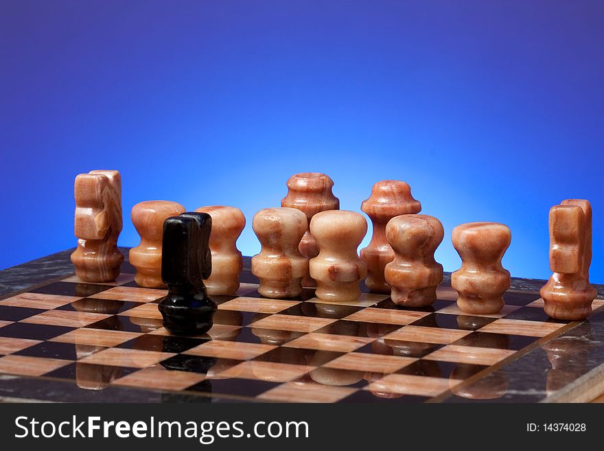 Chess game on board on blue background