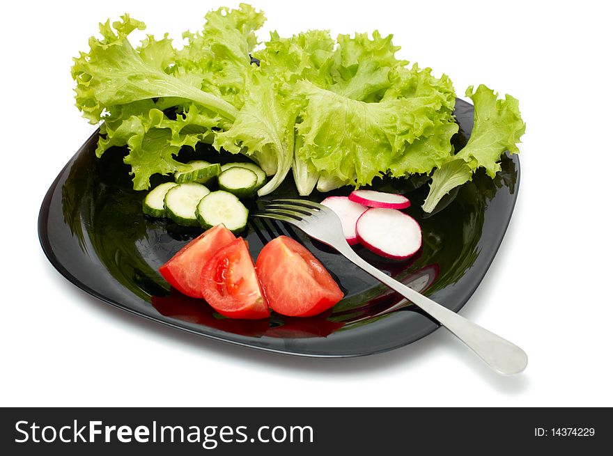 Fresh cucumber, radish, tomatoes and Lettuce on black plate. Vegetarian diet. Fresh cucumber, radish, tomatoes and Lettuce on black plate. Vegetarian diet.