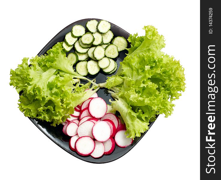 Fresh cucumber, radish and Lettuce on black plate isolated on white