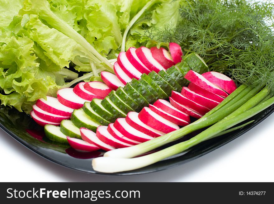 Fresh cucumber, radish and Lettuce on black plate. Fresh cucumber, radish and Lettuce on black plate