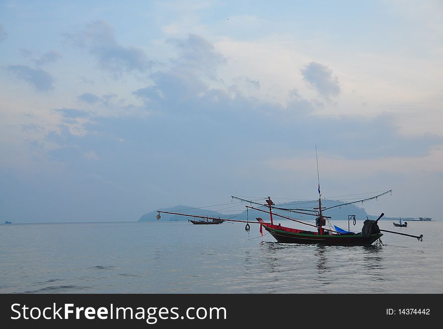 A photo of lonely fisherman boat in sea. A photo of lonely fisherman boat in sea