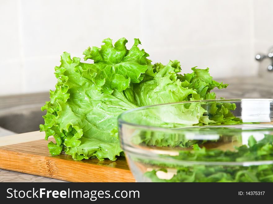 Fresh tasty lettuce on a cutting board on a kitchen. Fresh tasty lettuce on a cutting board on a kitchen