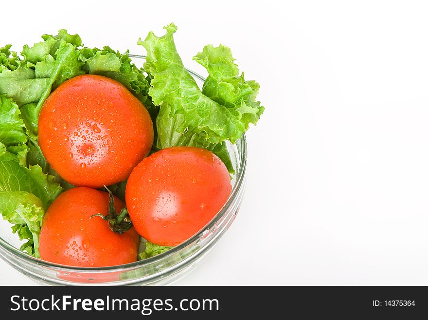 Fresh tomato and lettuce in bowl isolated on white