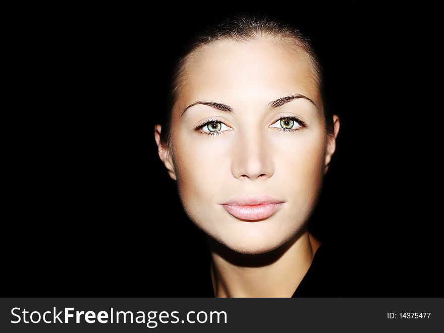 Portrait of a beautiful young lady over black background. Portrait of a beautiful young lady over black background